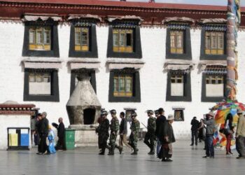 Tibet, China - Sep 7, 2012. Chinese soldiers walking at the Jokhang temple in Lhasa, Tibet. The Jokhang Temple has two Buddha statues sacred to Tibetan Buddhists. — Photo by phuongphoto