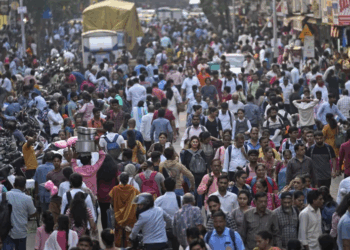 A large crowd walks in a market area outside Dadar station in Mumbai, India, Friday, March 17, 2023. [AP Photo/Rajanish Kakade]