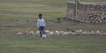 This photograph taken during a government-organized media tour shows a young boy standing near his house in Damxung county, in China’s Tibet Autonomous Region, in June 2021. (Photo: Hector Retamal/AFP)