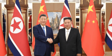 Xi Jinping, left, and Kim Jong Un, right, pictured shaking hands in this photo released by Xinhua. Xie Huanchi/Xinhua/AP
